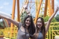 Teenage girls traveling in an amusement park. Two female are taking pictures of themselves in an amusement park Royalty Free Stock Photo