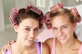 Teenage girls using curlers in their hair Royalty Free Stock Photo