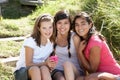 Teenage girls using phone outdoors Royalty Free Stock Photo