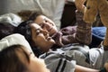 Teenage girls using smartphones on a bed internet in slumber party Royalty Free Stock Photo