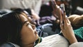 Teenage girls using smartphones on a bed Royalty Free Stock Photo