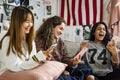 Teenage girls using smartphones in a bedroom internet in slumber party Royalty Free Stock Photo