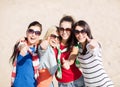 Teenage girls or young women showing thumbs up Royalty Free Stock Photo