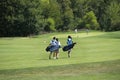 Teenage golfers walking to their next hole in golf Royalty Free Stock Photo