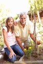 Teenage Granddaughter And Grandfather Relaxing In