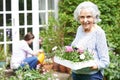 Teenage Granddaughter Helping Grandmother In Garden