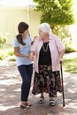 Teenage Granddaughter Helping Grandmother Out On Walk Royalty Free Stock Photo
