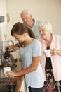 Teenage Granddaughter Sharing Cup Of Tea With Grandmother In Kitchen Royalty Free Stock Photo