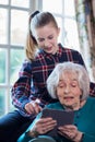 Teenage Granddaughter Showing Grandmother How To Use Digital Tab Royalty Free Stock Photo