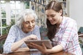 Teenage Granddaughter Showing Grandmother How To Use Digital Tab Royalty Free Stock Photo