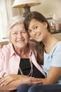 Teenage Granddaughter Visiting Grandmother At Home Royalty Free Stock Photo