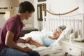 Teenage Grandson Visiting Grandmother In Bed At Home Royalty Free Stock Photo