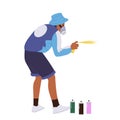 Teenage guy street artist cartoon character wearing respirator painting on wall with spray aerosol