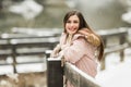 Teenage high school senior smiling in flurries wearing winter clothes outside