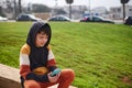 Teenage hipster boy sitting on steps and using smart phone, checking social media content or playing online video games