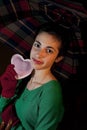 Teenage holding a heart under umbrella