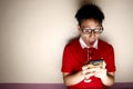 Teenage kid using a smartphone and acting surprised Royalty Free Stock Photo