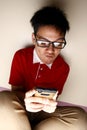 Teenage kid using a smartphone intensely Royalty Free Stock Photo