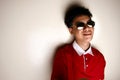 Teenage kid wearing a red shirt and sunglasses Royalty Free Stock Photo