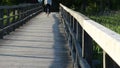 Teenage male ride fast bicicle on wooden bridge in park