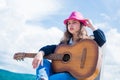 Teenage musician playing guitar. Portrait of little kid playing guitar on sky background. summer romantic playlist Royalty Free Stock Photo