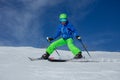 Teenage person ski on a snowy slope with blue sky in backdrop Royalty Free Stock Photo
