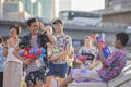 Teenage plays water with his friends during Songkran