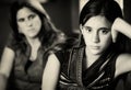 Defiant teenage girl and her worried mother Royalty Free Stock Photo