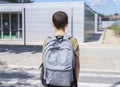 Teenage school boy with a backpack on his back walking to school Royalty Free Stock Photo