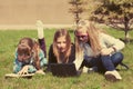 Teenage school girls lying on a grass in campus Royalty Free Stock Photo