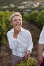 Teenage schoolboy boy in a white shirt stands in a vineyard at sunset Royalty Free Stock Photo