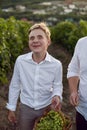 Teenage schoolboy boy in a white shirt stands in a vineyard at sunset Royalty Free Stock Photo