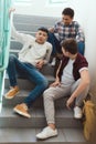 teenage schoolboys sitting on stairs