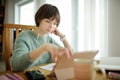 Teenage schoolgirl doing her homework with digital tablet at home. Child using gadgets to study. Education and distance learning Royalty Free Stock Photo