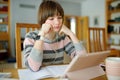 Teenage schoolgirl doing her homework with digital tablet at home. Child using gadgets to study. Education and distance learning Royalty Free Stock Photo