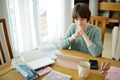 Teenage schoolgirl doing her homework with digital tablet at home. Child using gadgets to study. Education and distance learning Royalty Free Stock Photo