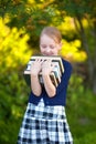 Teenage schoolgirl holding pile of books and smiling Royalty Free Stock Photo