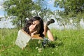 Teenage schoolgirl reading book in grass Royalty Free Stock Photo