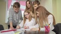 Teenage schoolkids preparing for exams together, working on laptop