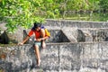 Teenage sitting on wall in Indonesia.