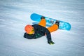 Teenage snowbarder falling and tumbling down