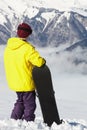 Teenage Snowboarder Admiring Mountain View