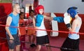 Teenage sportsman at boxing workout with coach