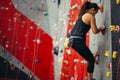 Teenage girl in a free climbing wall Royalty Free Stock Photo