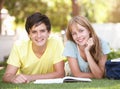 Teenage Student Couple Studying In Park