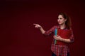 Teen student girl isolated on a red background pointing her finger to the side Royalty Free Stock Photo