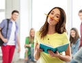 Teenage student girl with notebook and pencil