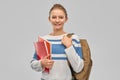 Teenage student girl with school bag and notebooks