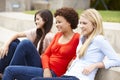 Teenage student girls sitting outdoors Royalty Free Stock Photo