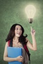 Teenage student with light bulb get an idea Royalty Free Stock Photo